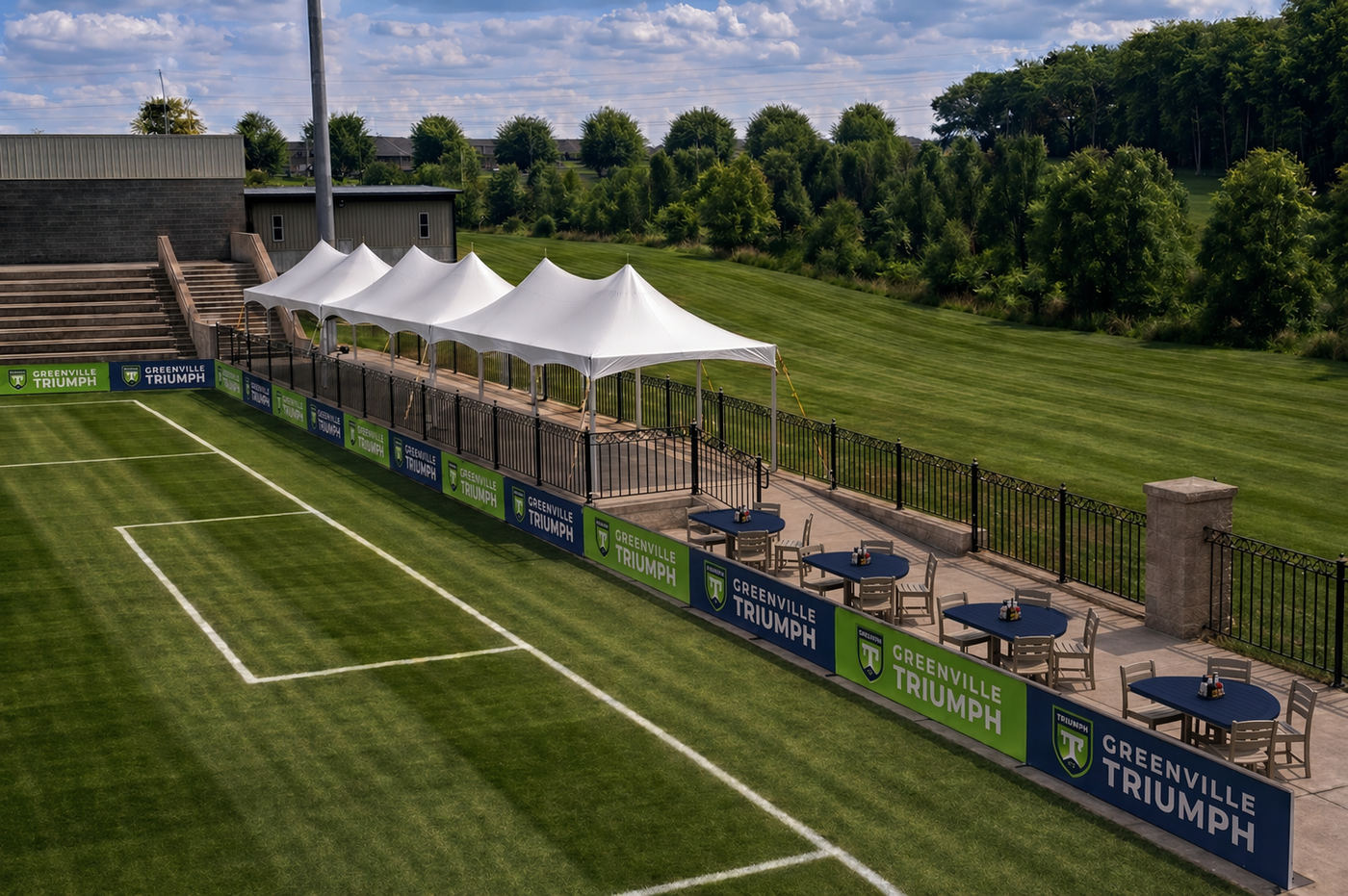 Render of VIP Field Tables on the pitch rail at the south end, with the stage tents behind
